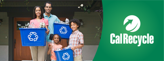 Family holding recyclables in bins in front of their house.