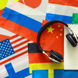 foreign country flags with headphones laying on top symbolizing language interpretation for meetings