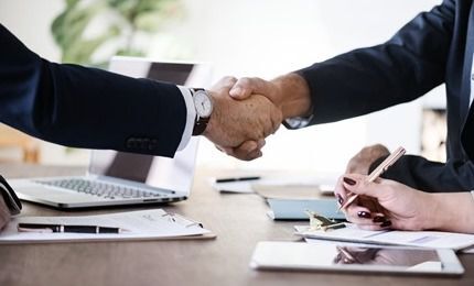 Two people shake hands