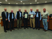 Jey Lewitt presents Glen Peterson with his retirement proclamation, joined by the rest of the LVMWD Board of Directors and GM