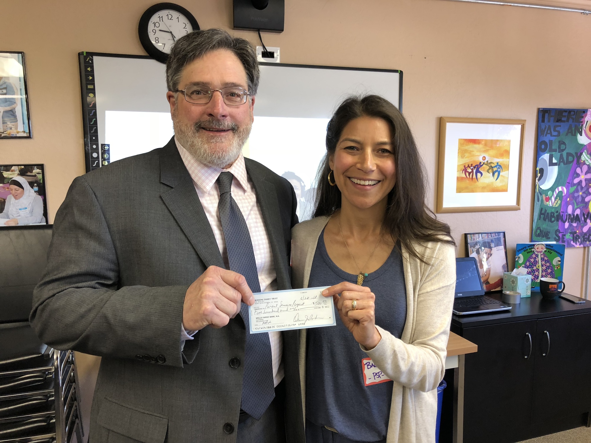 Supervisor Dennis Rodoni presenting check to Balandra Fregoso of Parent Services project in East San Rafael