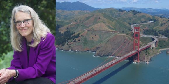 Kate Sears smiles at the camera, wearing a purple blouse. The Golden Gate Bridge with the Marin Headlands in the background.
