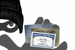A criminal holding a social security card, credit card, and debit card.