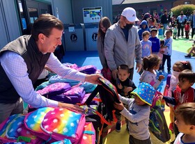 Eric and attendees at MCFL Learning Bus backpack give-away