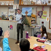 Eric showing students a picture of the watch for wildlife signs at Olive Elementary School