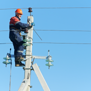 pg&e worker fixing wires on a electric pole