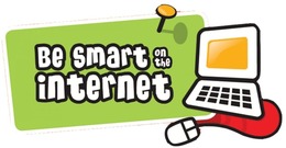A sign that says "Be smart on the internet" next to a computer.