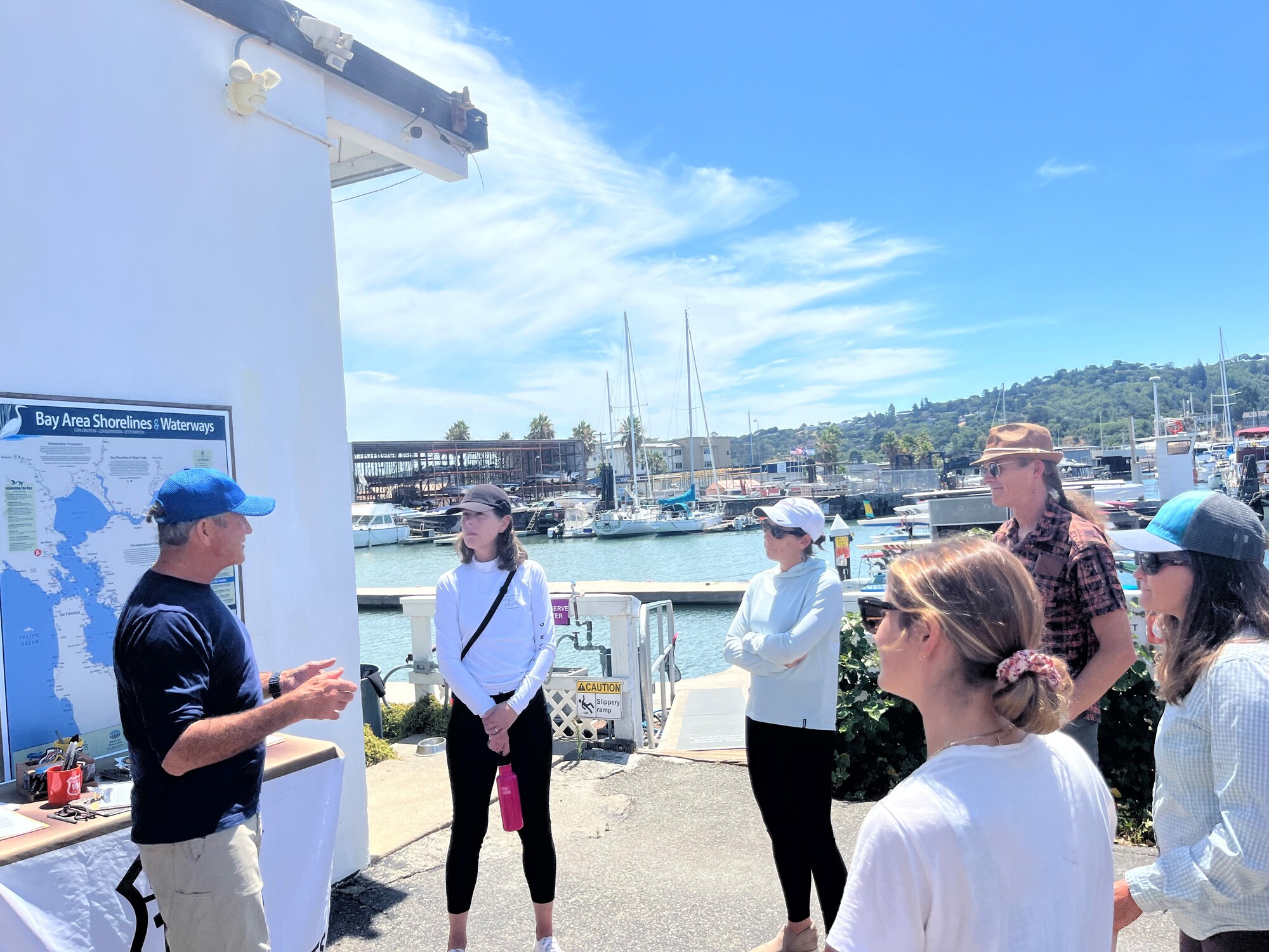 group listening in a circle to 101 Surf Sports Owner, Cort