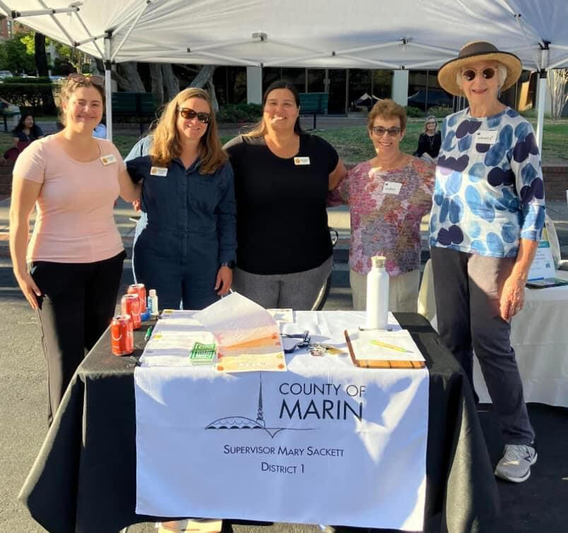 tabling at the farmers market smiling toward camera