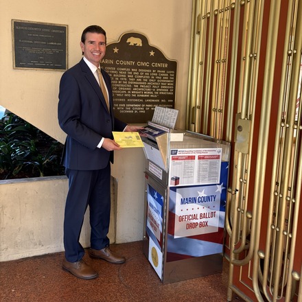 Eric putting ballot in election ballot box. 