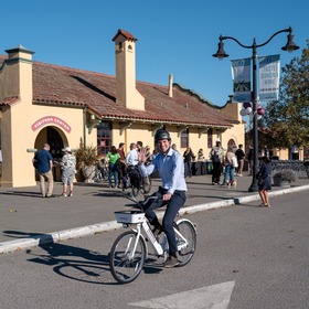 Supervisor Lucan test riding a Redwood Bikeshare bike