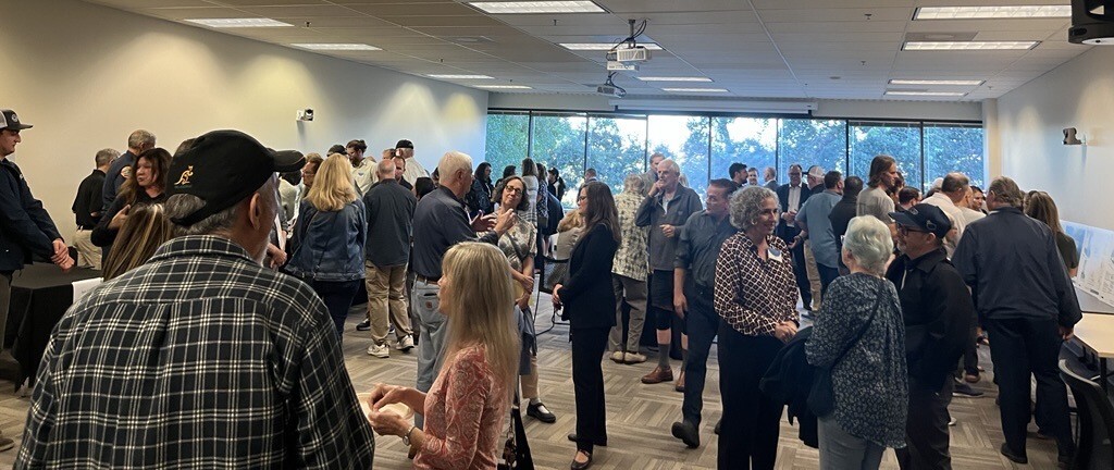 view of room with folks mingling at Marinwood open house event