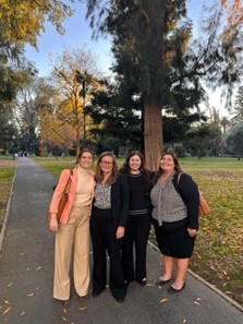 Supervisor Sackett and staff on tree-lined pathway smiling toward camera 