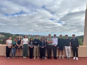 group photo on Civic Center balcony smiling toward camera