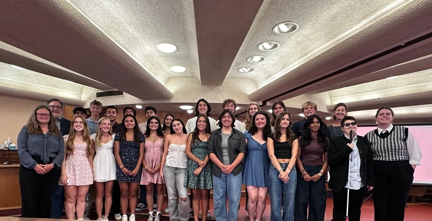Group photo of Commissioners and Supervisors smiling on Board chambers stage 