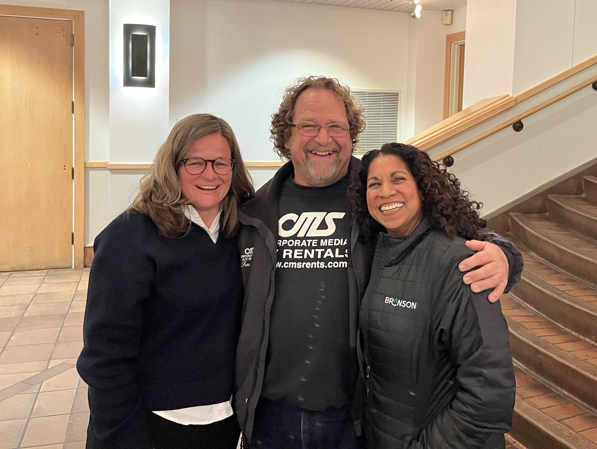 Mary smiling toward camera with two constituents