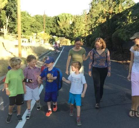 Mary walking with a friend and their walking school bus to Vallecito