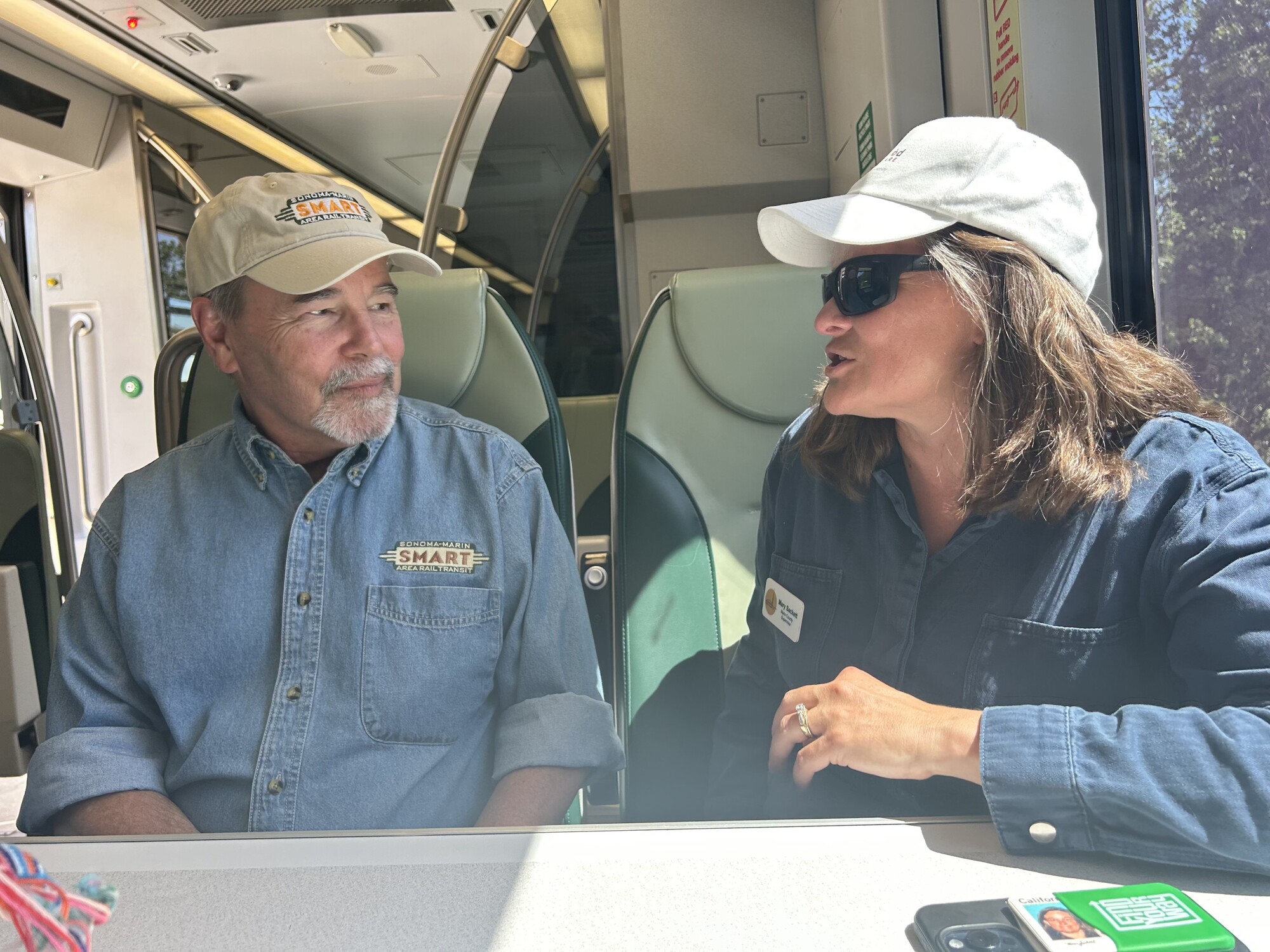 Mary talking to Chris on train