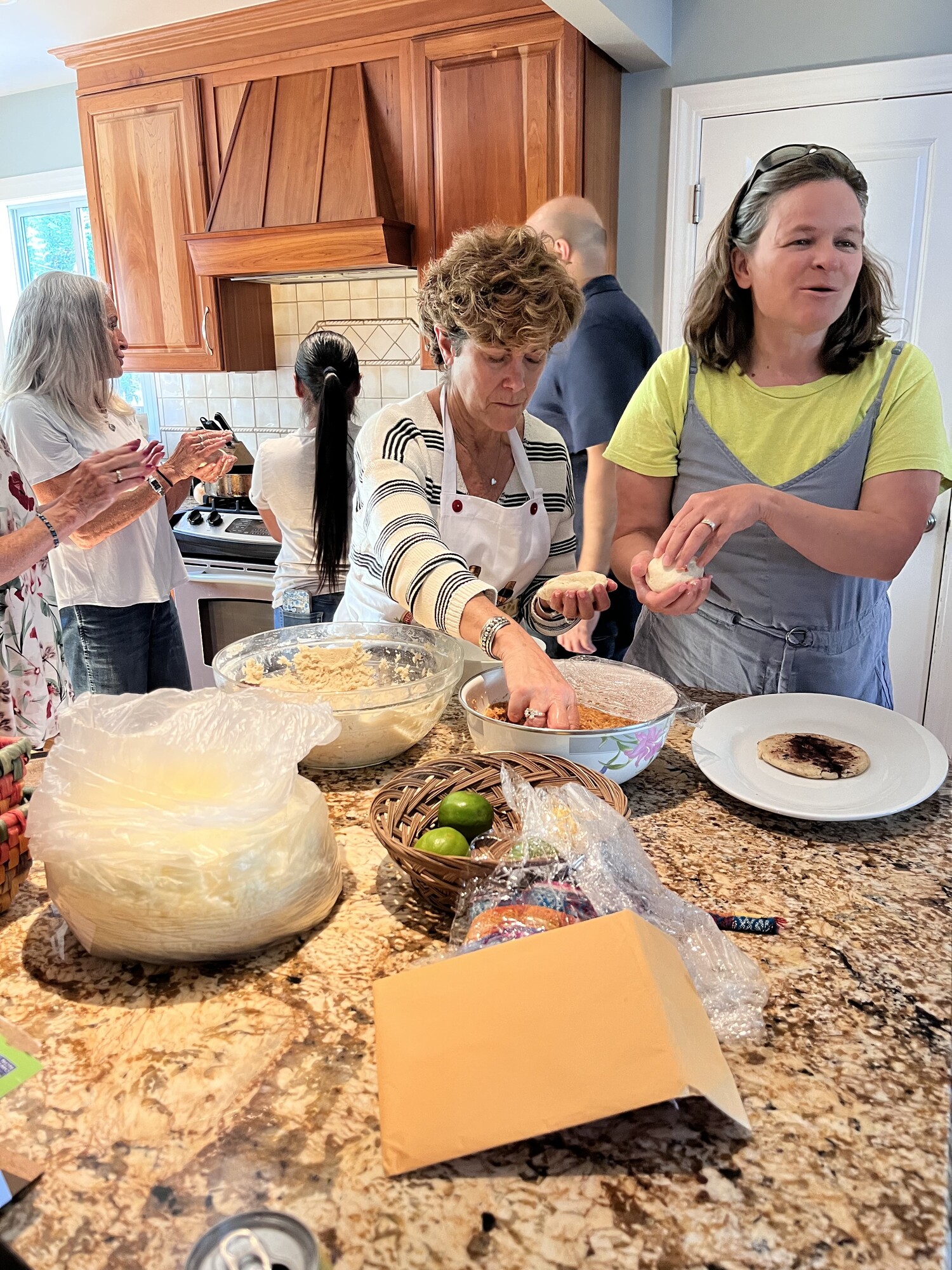 Making pupusas around kitchen island