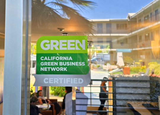 Photo of Green Business Certified decal in window of Marin Suites Hotel