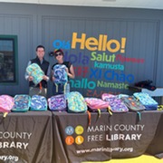 Distributing backpacks at the Novato Library