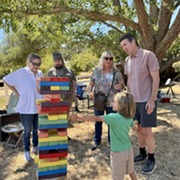 Playing Giant Jenga at the Black Point and Green Point Summer Party