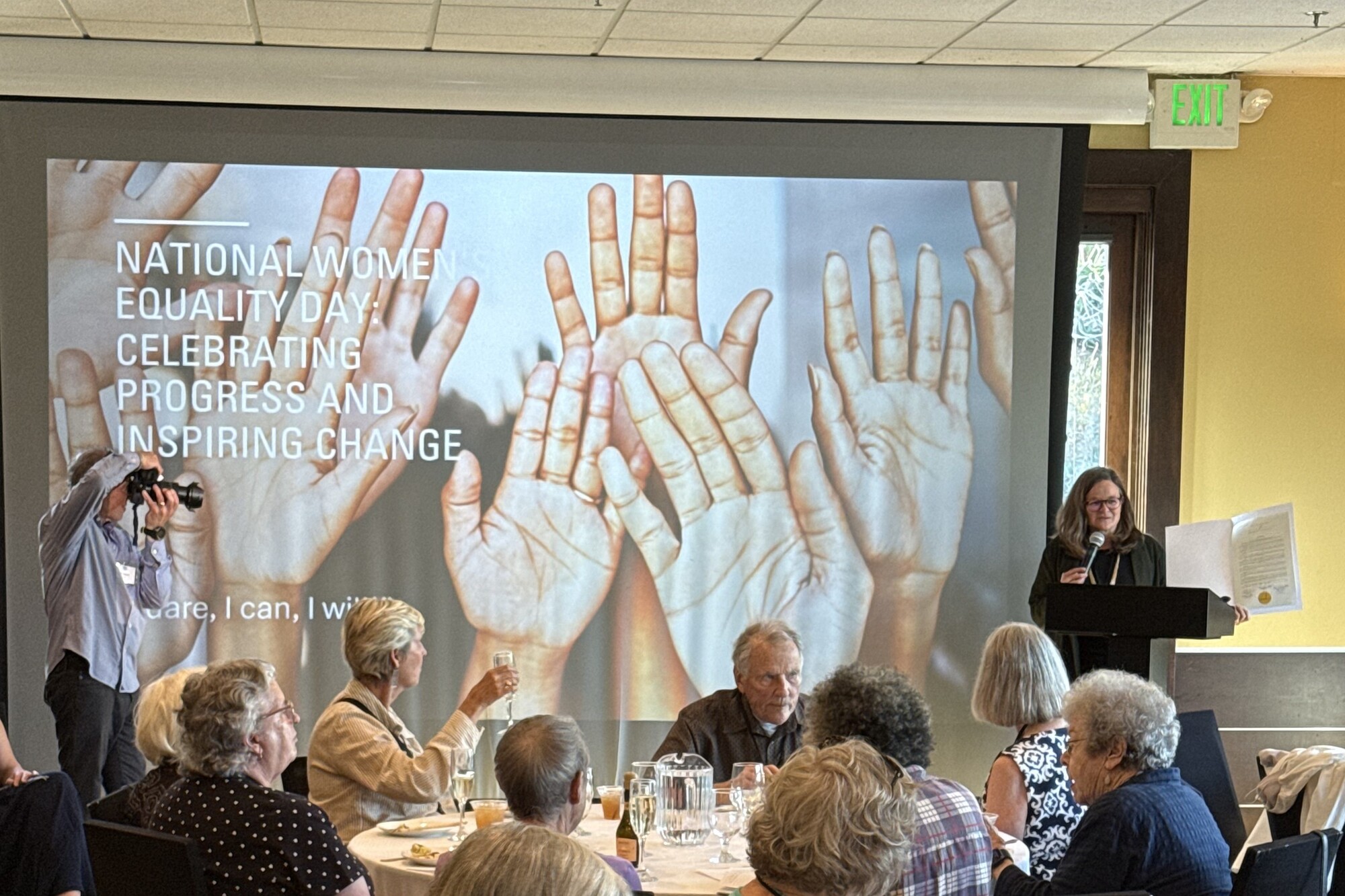 Mary speaking to audience of League of Women Voters