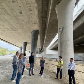 Eric Lucan and a group of people touring the Highway 101 widening project from under the highway