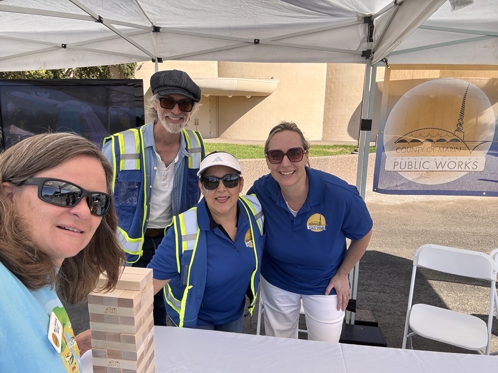 Mary and county employees at a table with Jenga game