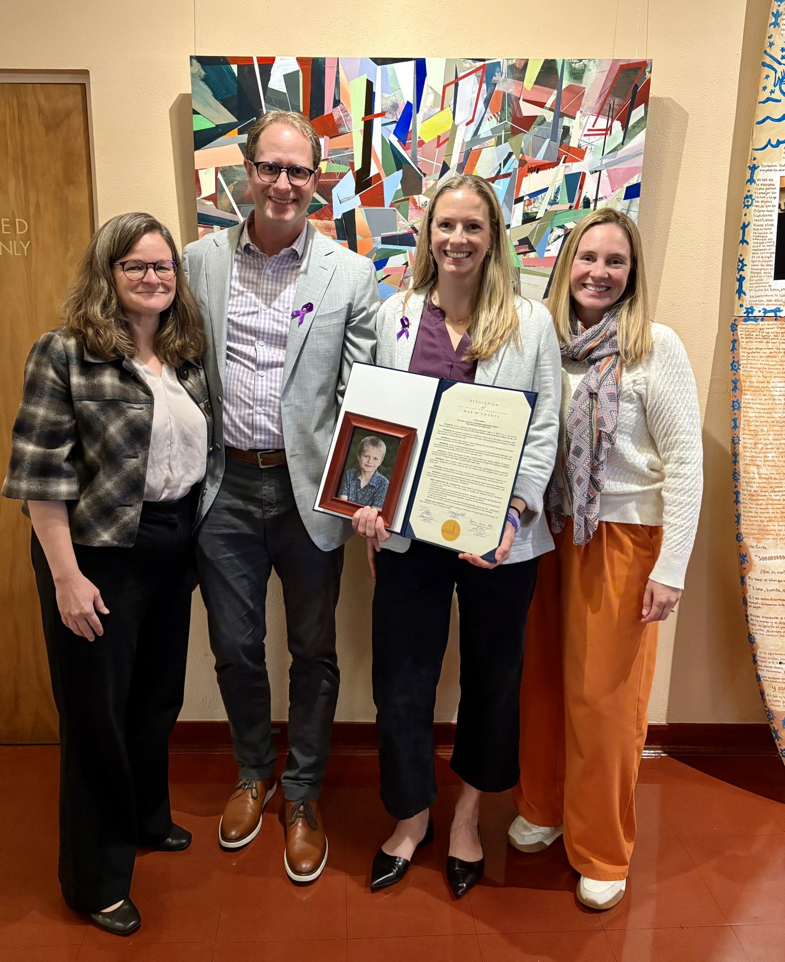 Mary, Jen Imbimbo and Supporters holding resolution recognizing Hunters Syndrome Awareness Week