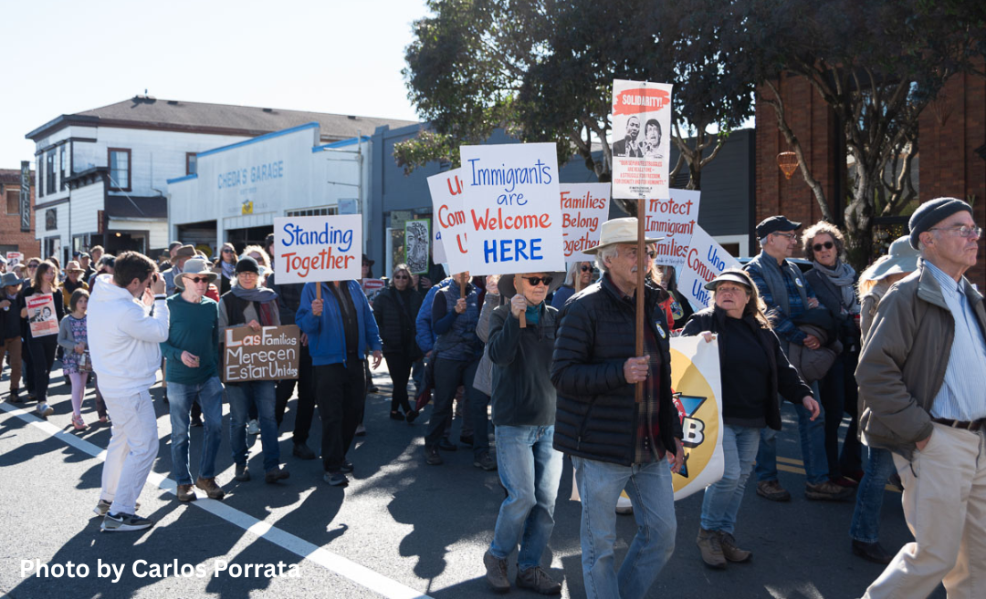 People marching in Point Reyes Station in support of immigrants
