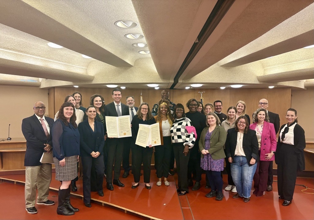 County employees on Board Chambers stage with 175 Resolution