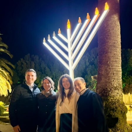 Supervisor Lucan and other attendees standing in front of a menorah at the Sausalito Menorah Lighting. 