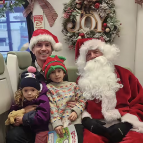 Supervisor Lucan and his children with Santa on the SMART Train