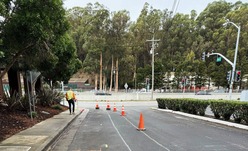 A construction worker in a hardhat walks through the construction zone of this project.