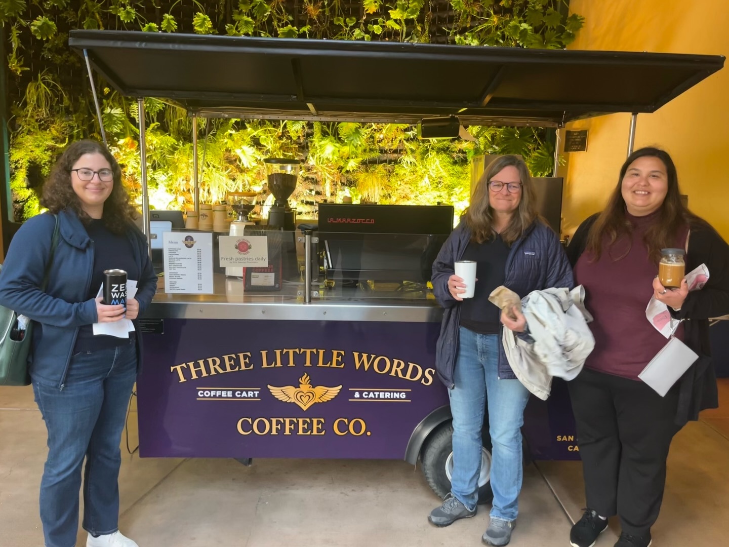 D1 team standing in front of Three Little Words Coffee Cart