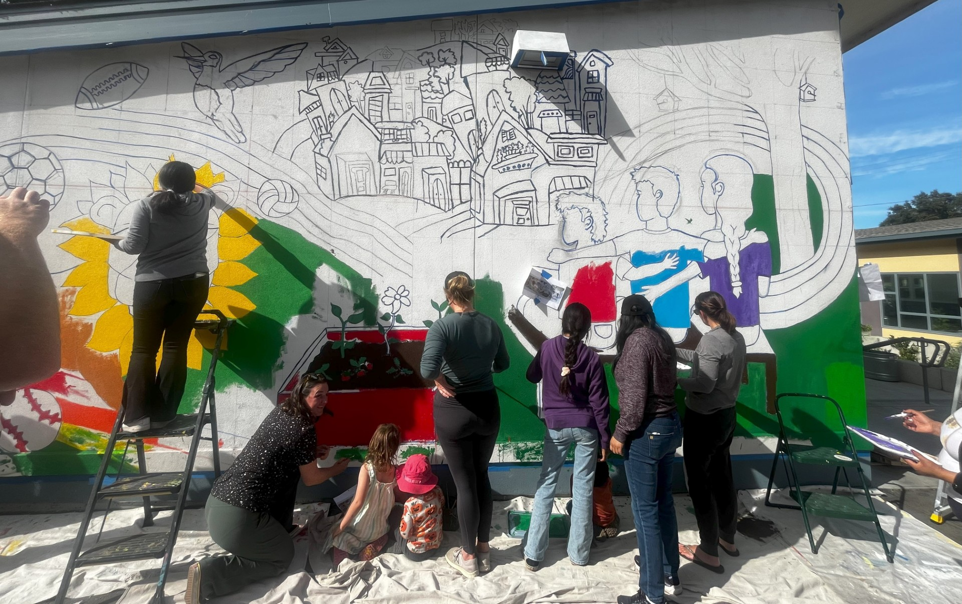 people painting mural