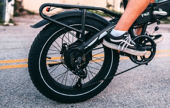Close-up of an e-bike's chain, sprocket and tire. 