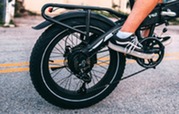 Close-up of an e-bike's chain, sprocket and tire. 