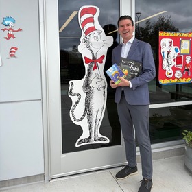 Supervisor Lucan holding books at Olive School