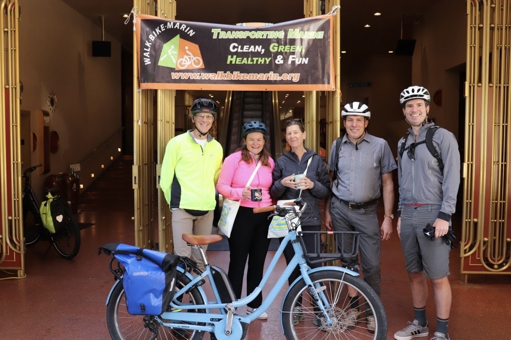 Mary and Cory Bytoff, Dr. Willis, Eric Lucan, and Kate Rice, with Bike in front of Civic Center Entry
