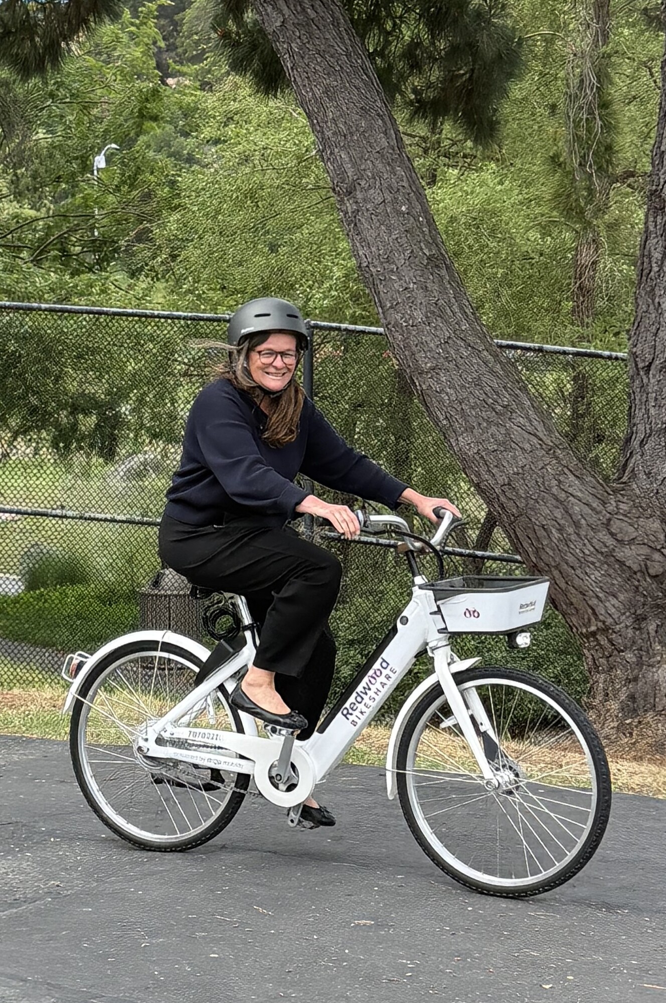 Mary on Redwood Bikshare ebike smiling for photo 