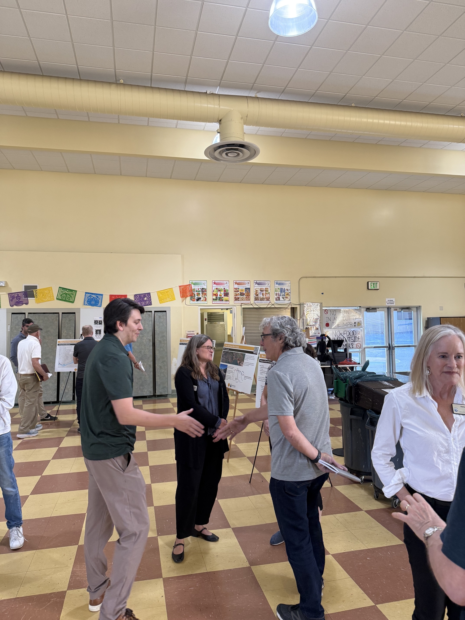 Mary speaking with residents with Mayor Kate and Robert Sandoval