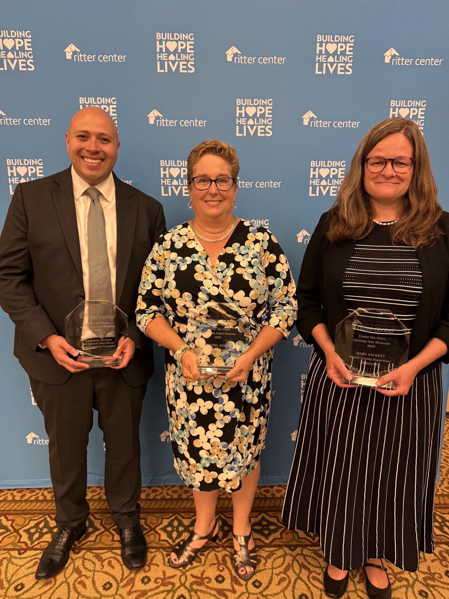 Mario Lopez, Rachel Kertz, Mary Sackett standing with awards