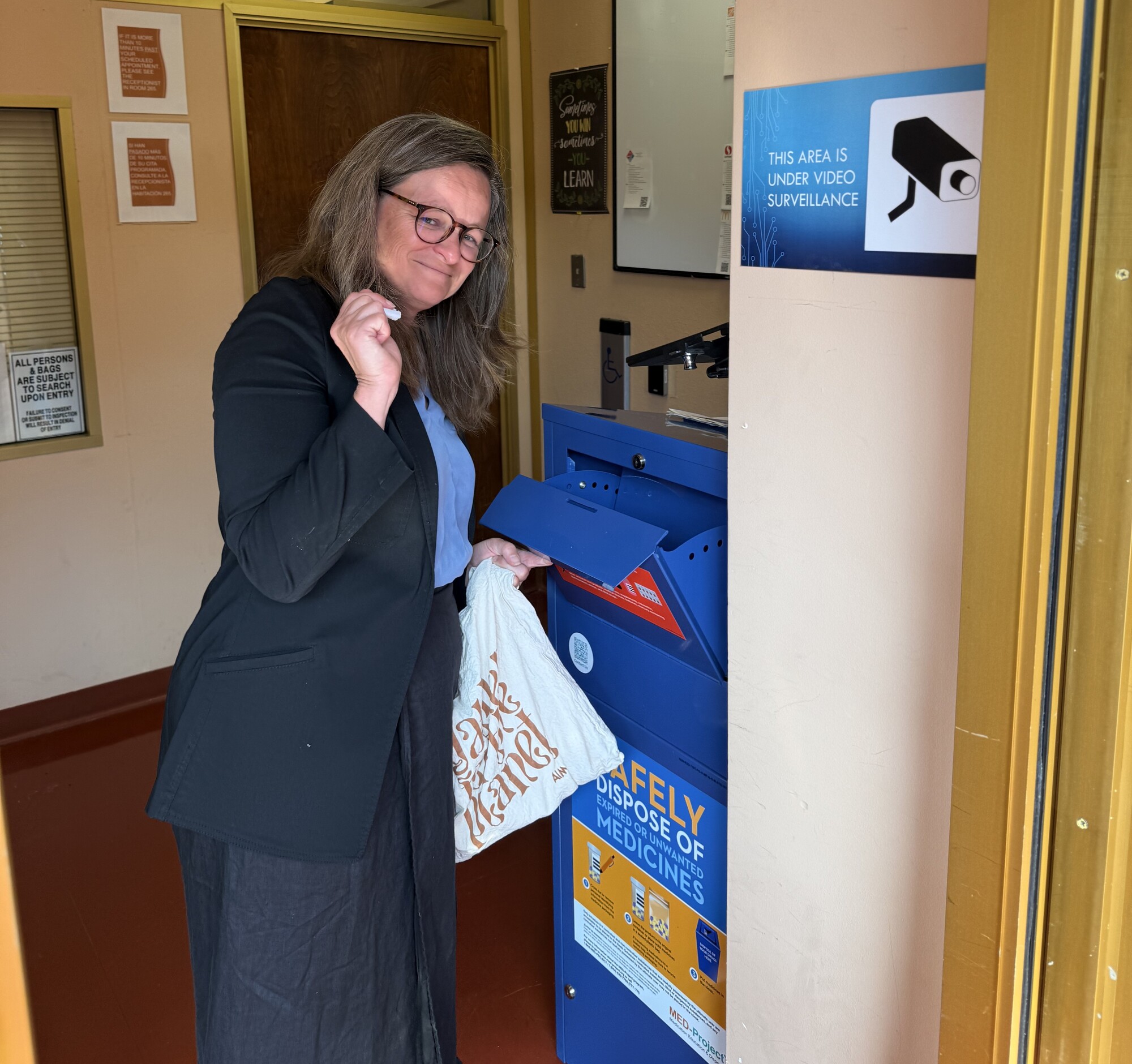 Mary Disposing Pharmaceuticals in Medicine Drop Off Receptacle