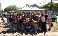 Several dozen people pose and wave during an event that was funded by participatory budgeting.