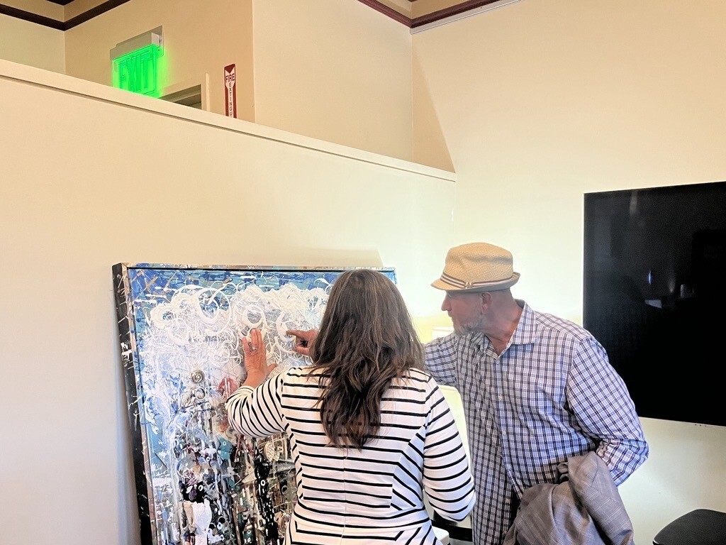 Mary speaking with local artist viewing painting