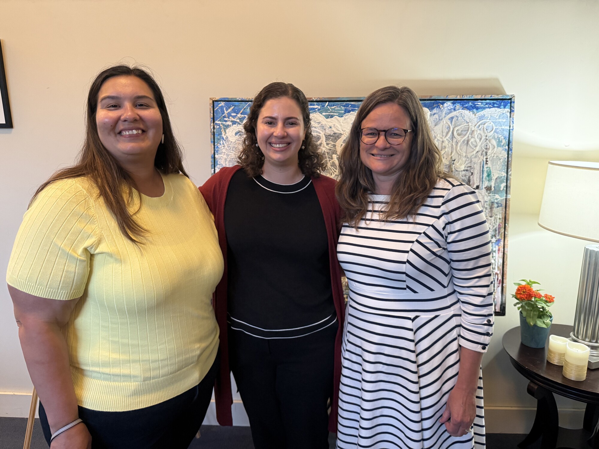 Crystal, Julia, and Mary standing infront of a painting