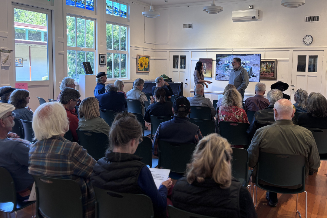 People sitting in a room listening to a presentation 