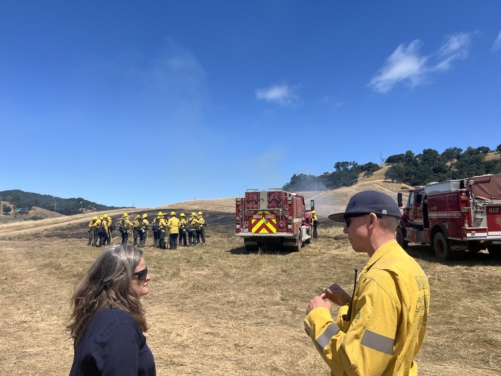Mary speaking with a firefighter at St. Vincent's